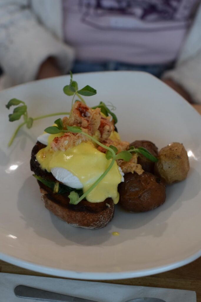 Plate with lobster benedict and potatoes at Bistro Mirepoix in St. Catharines, Ontario