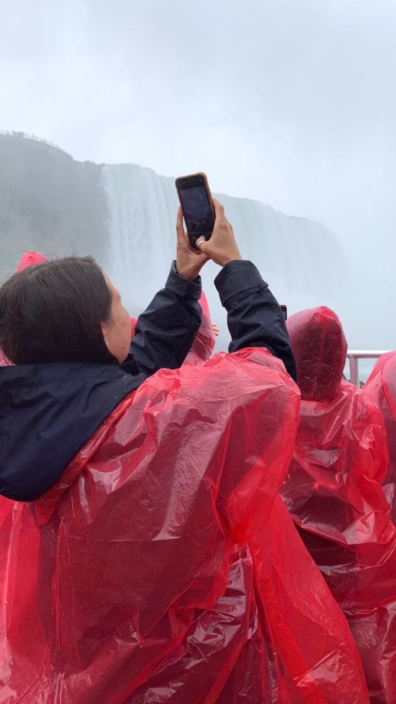 Person taking photos of the Horseshoe Falls on the Niagara City Cruises boat tour