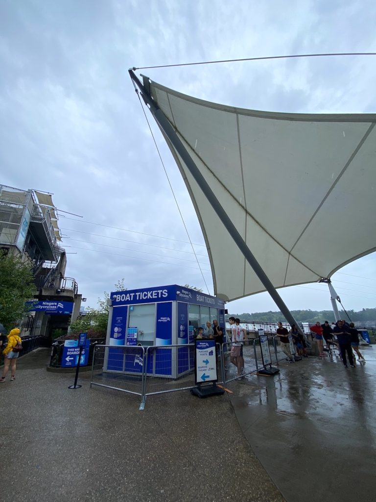 Niagara City Cruises ticket booth beside a large white sail