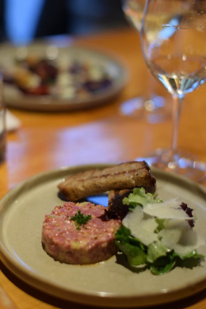 Beef tartare with a piece of crostini and lettuce with cheese at Ravine Winery Restaurant in Niagara-on-the-Lake